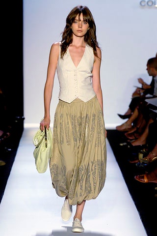 white fitted vest with beige pleated skirt