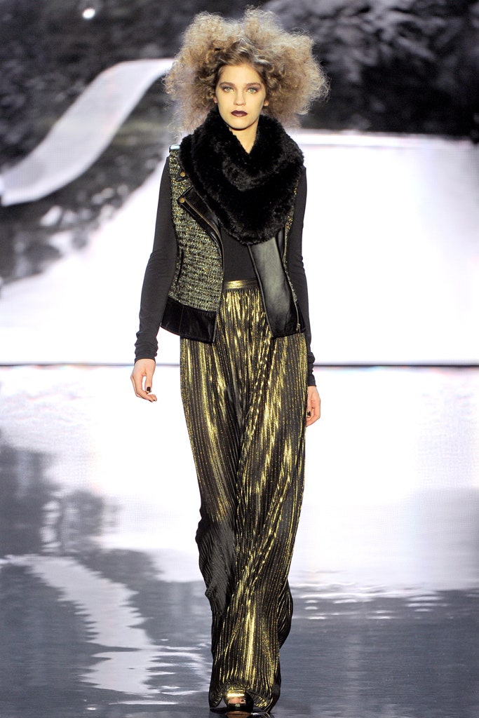 black fur vest with gold pleated pants