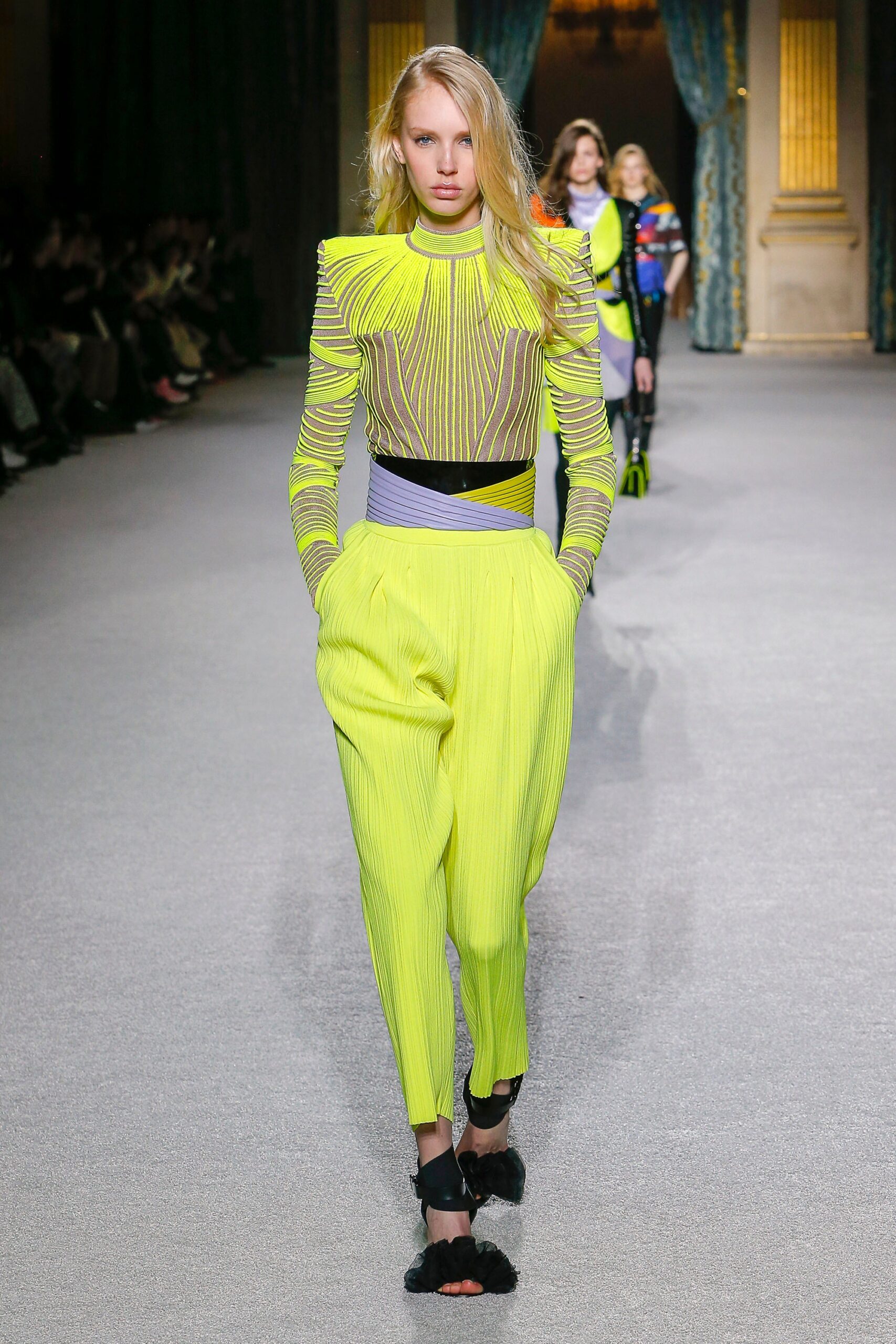 fitted black mesh top with pleated yellow pants