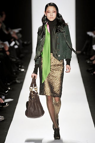green jacket black top gold skirt