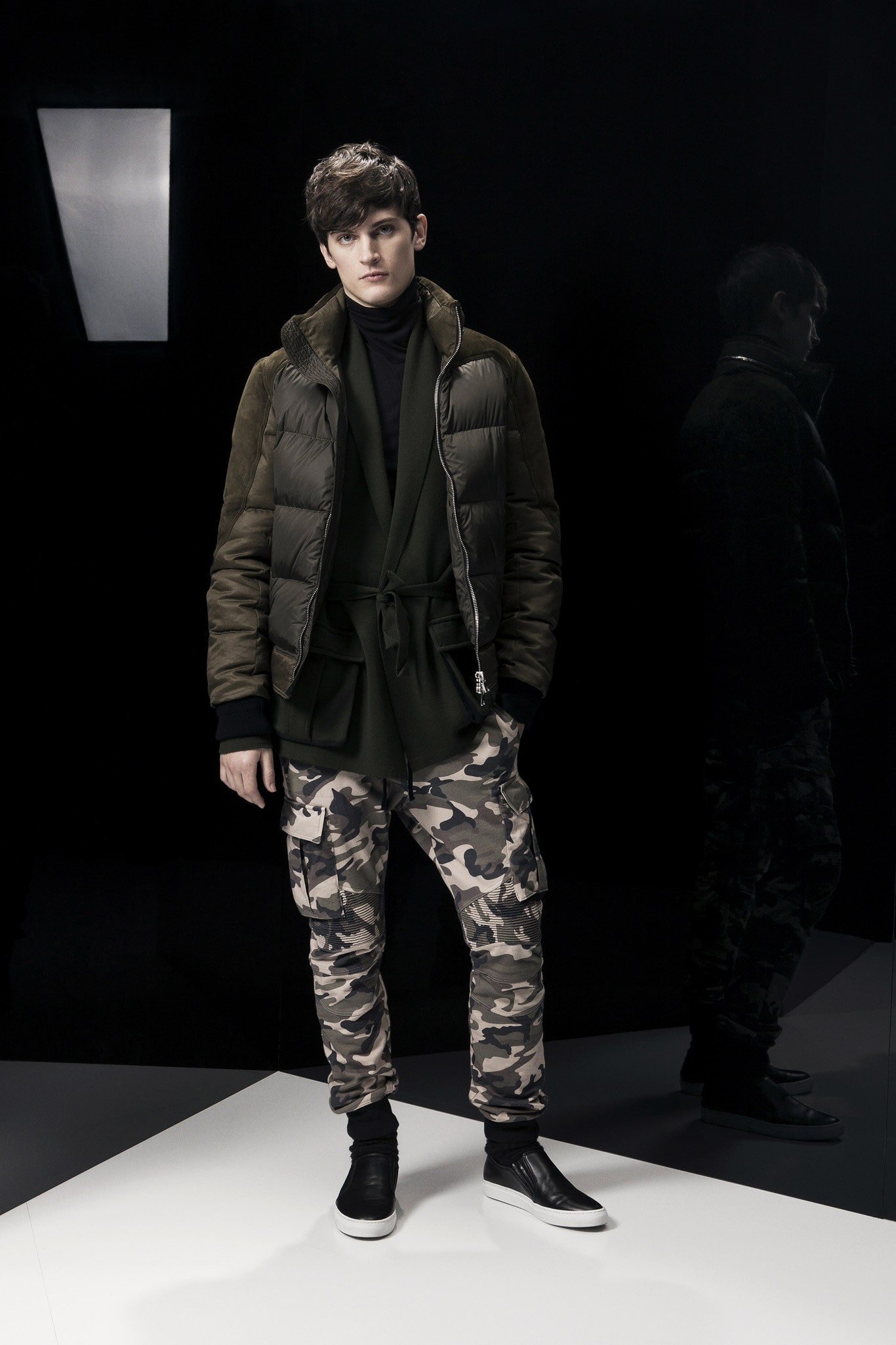 green jacket black top camouflage pants