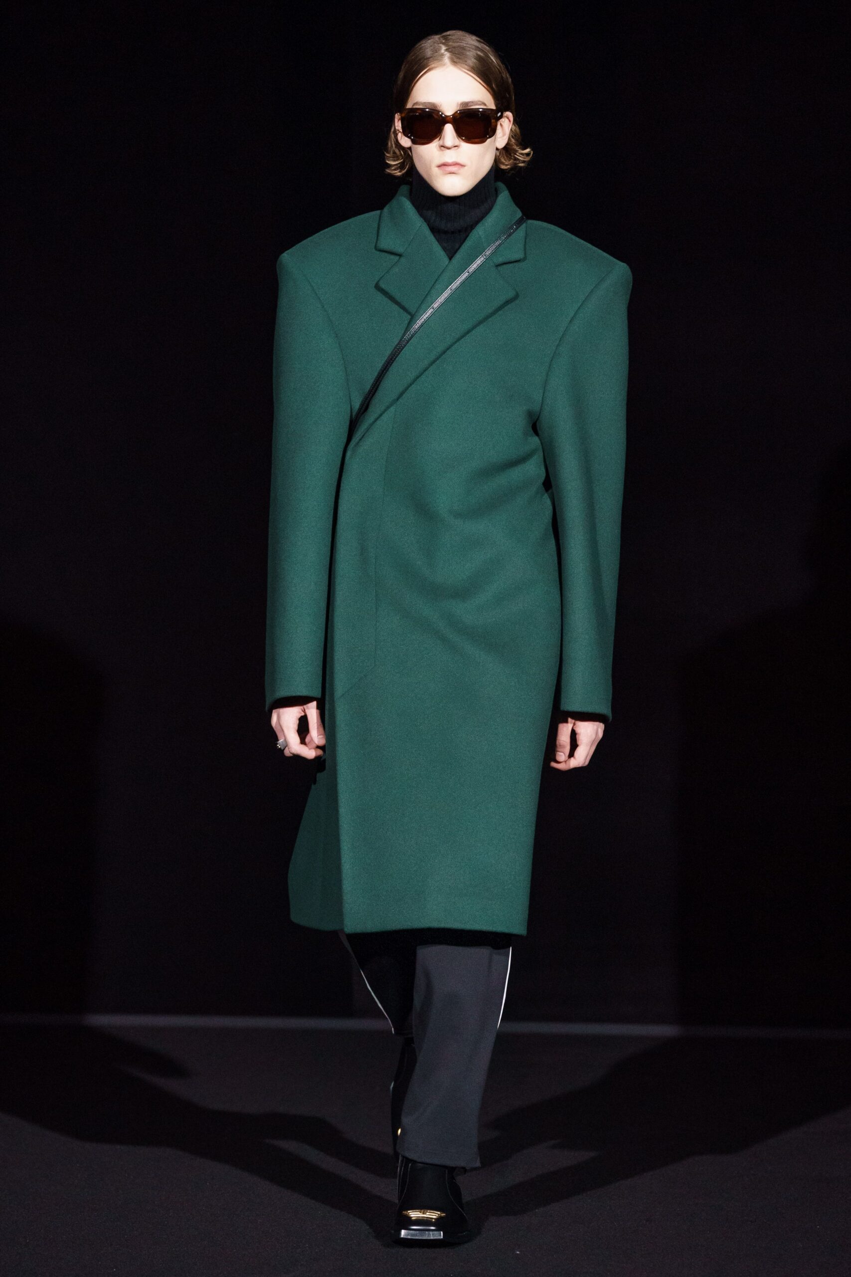 green structured coat with black pants