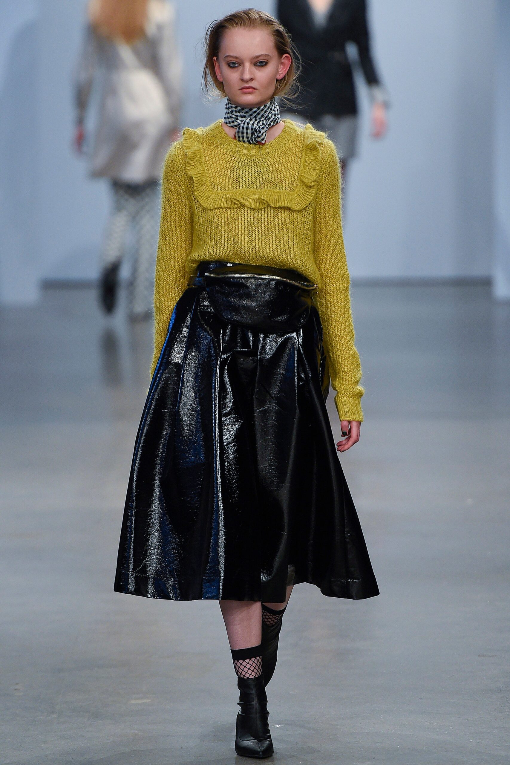 yellow wool fitted sweater and black vinyl skirt