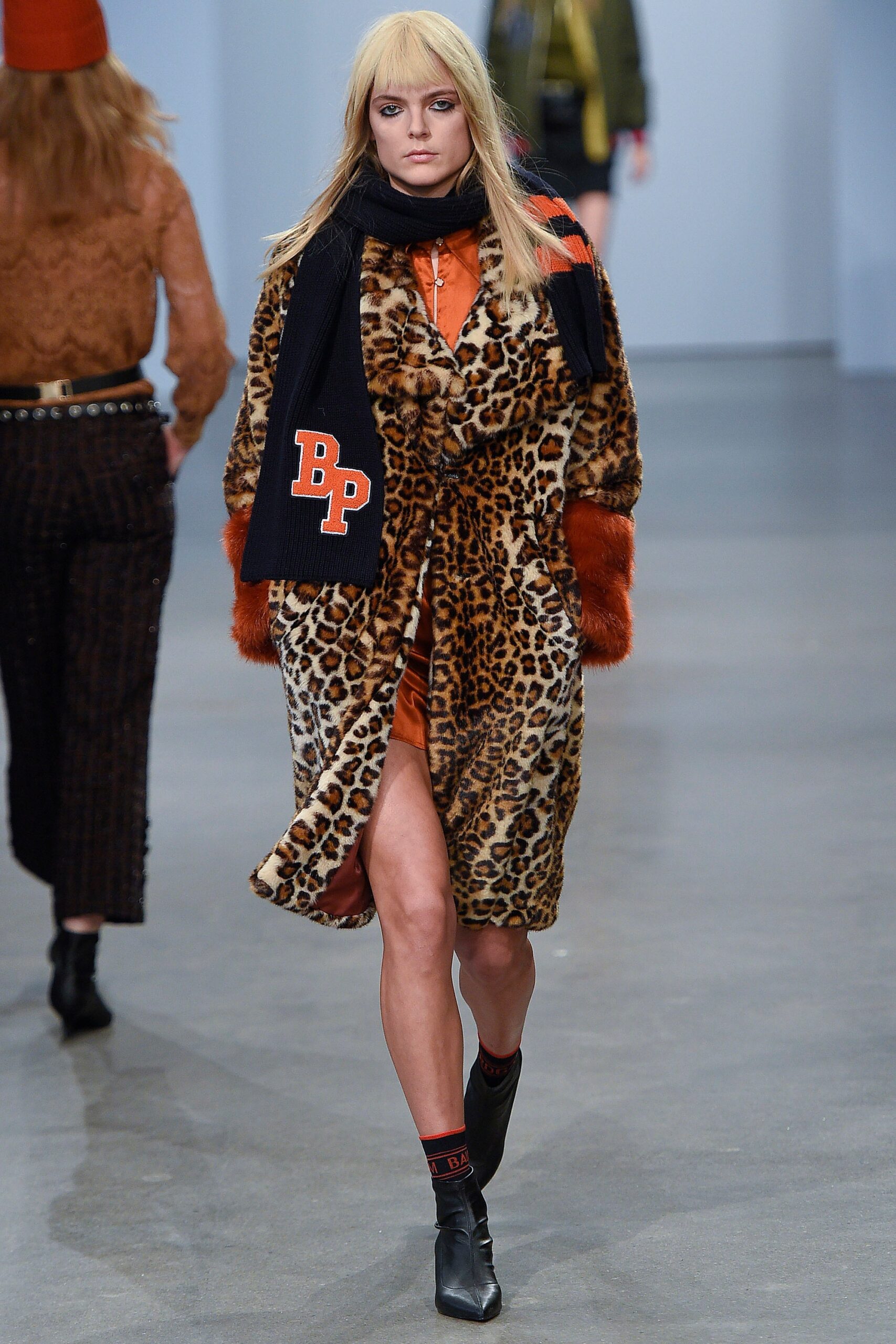 brown faux-fur coat with orange dress
