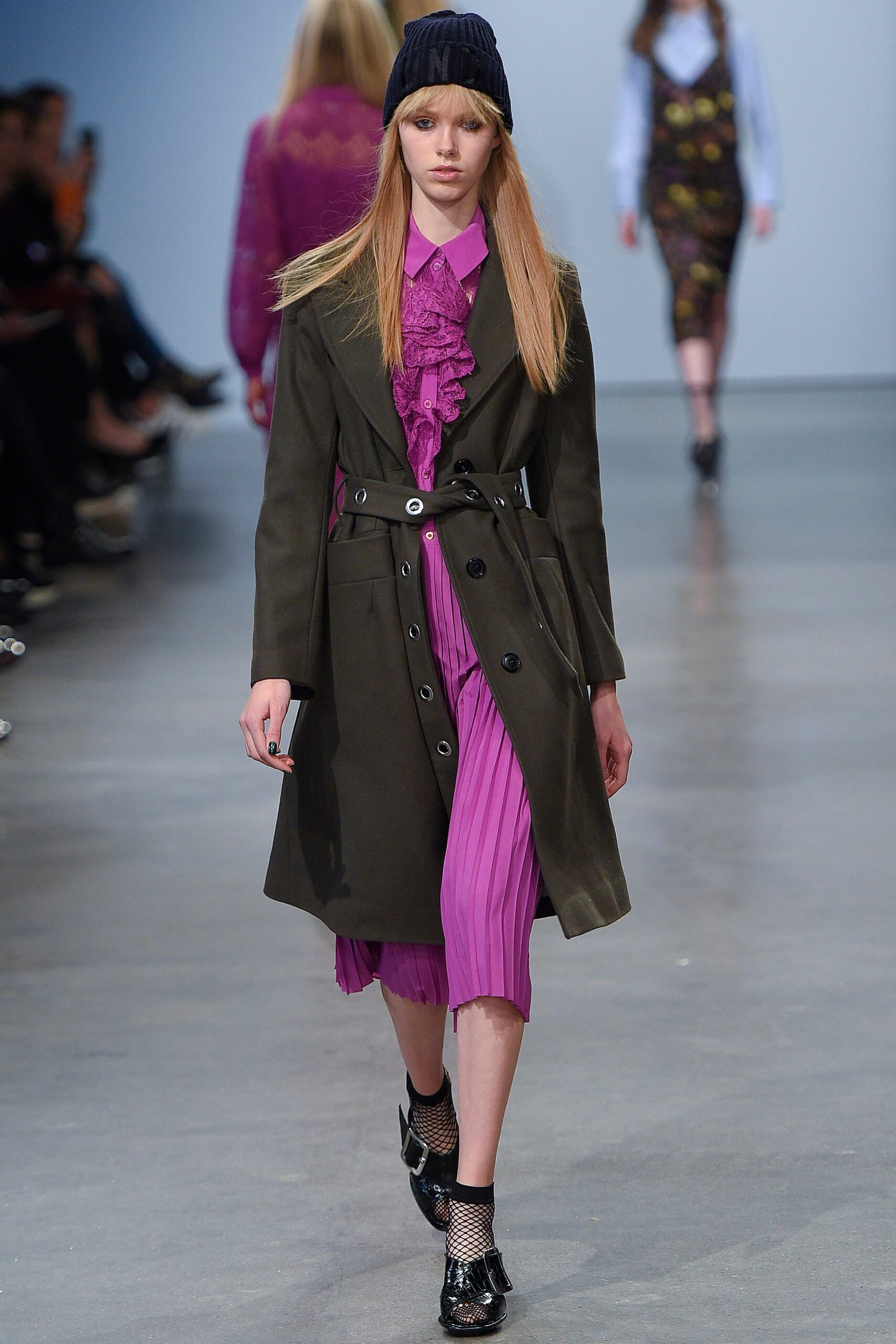 olive coat and purple dress