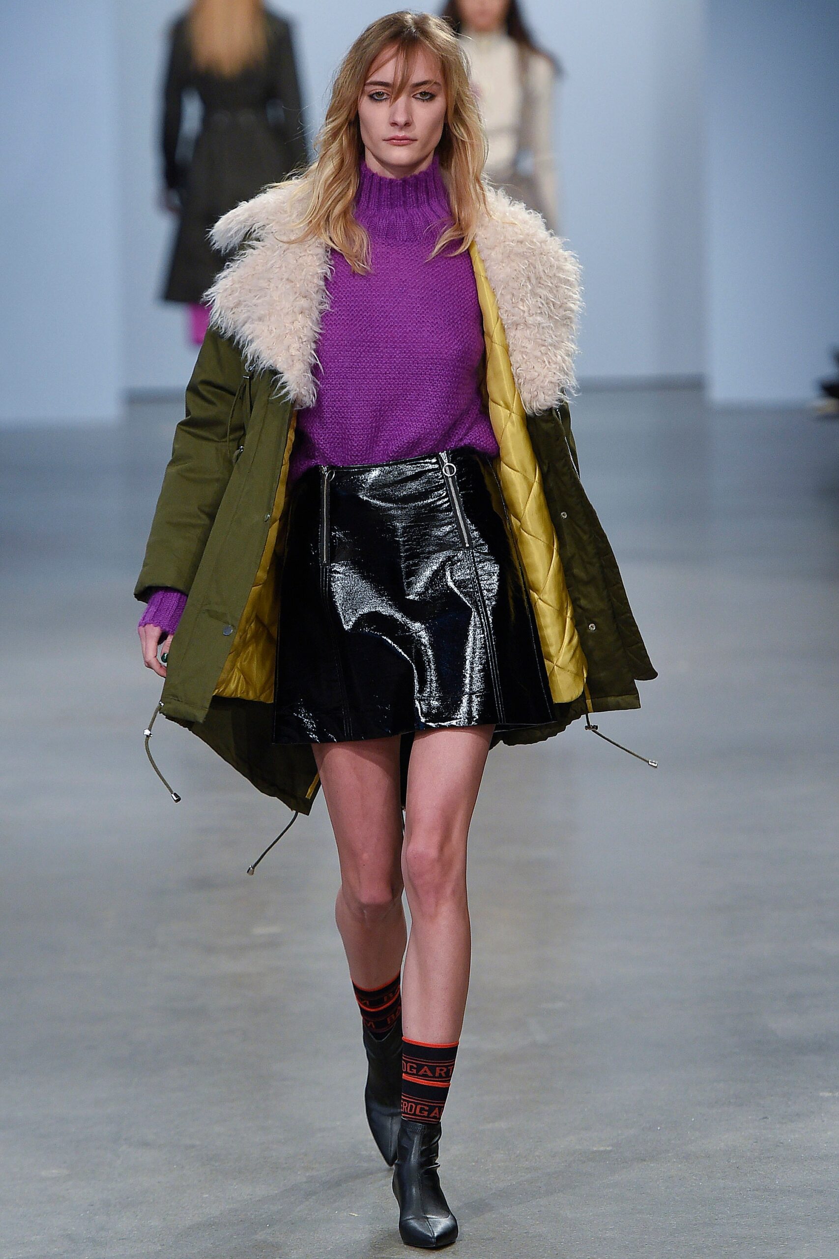 green parka purple sweater black vinyl skirt