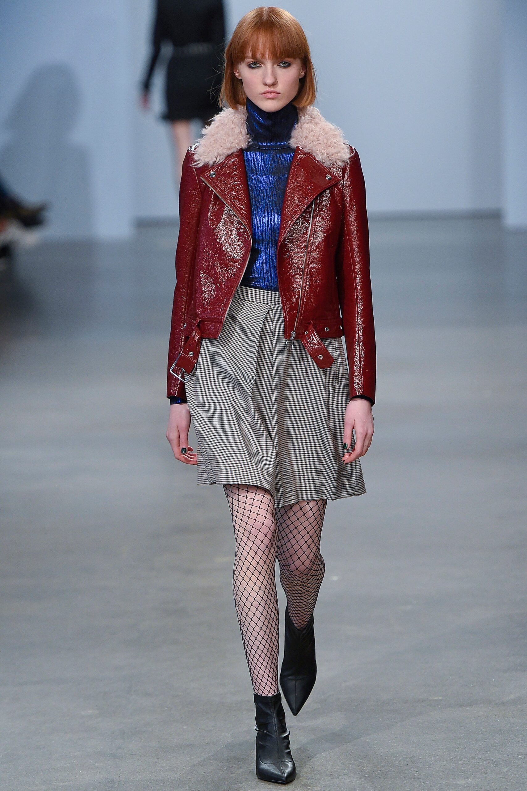 red leather jacket with blue top and gray skirt