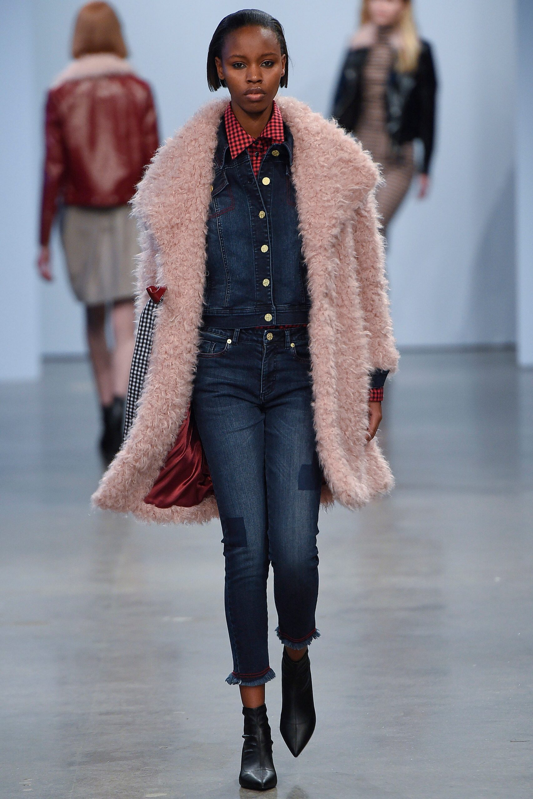 pink faux-fur coat and blue denim jumpsuit