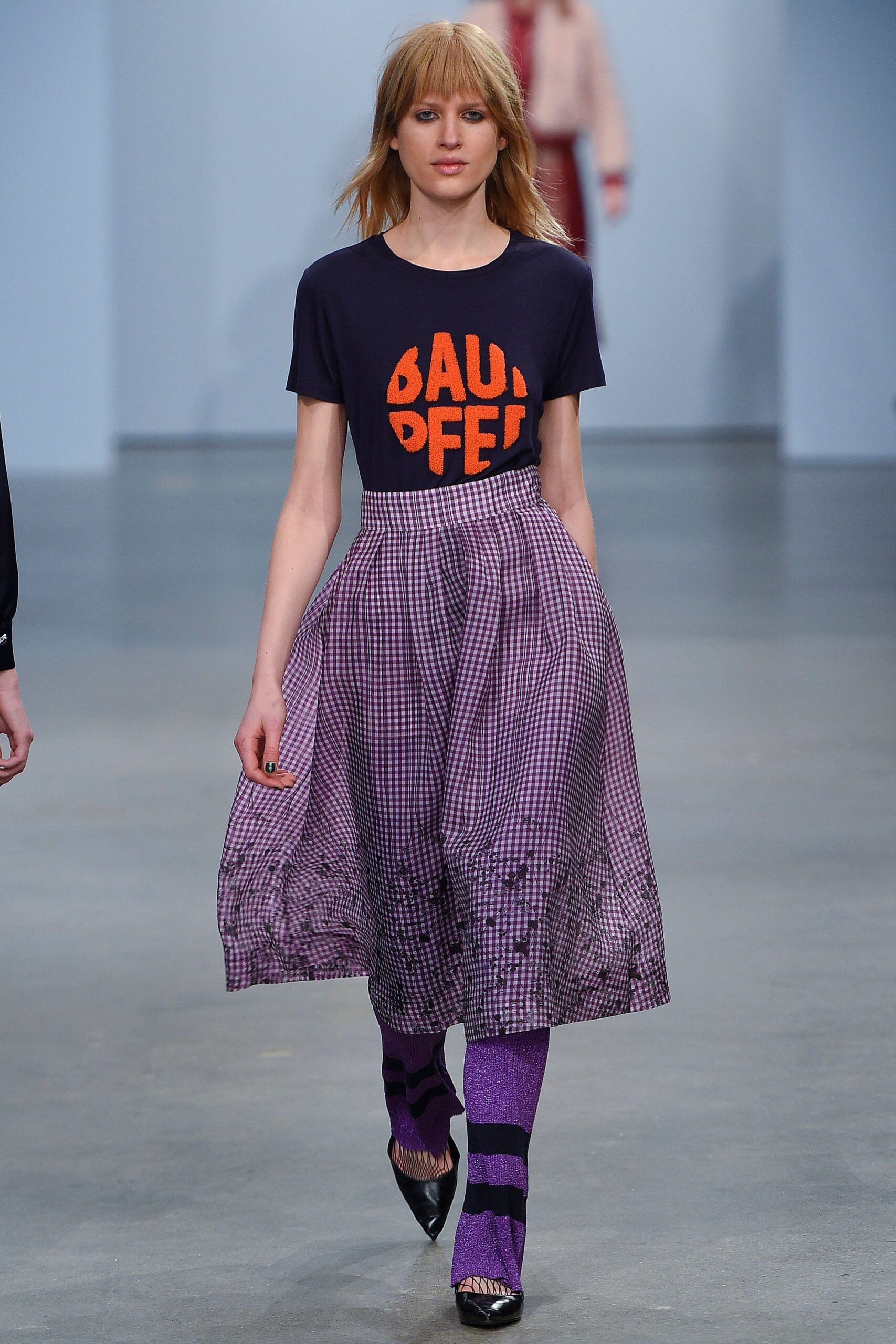 black orange fitted top with purple pleated skirt
