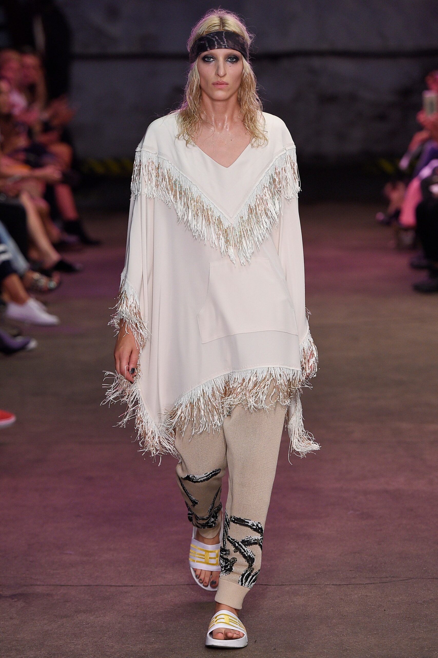 white fringed poncho with beige pants
