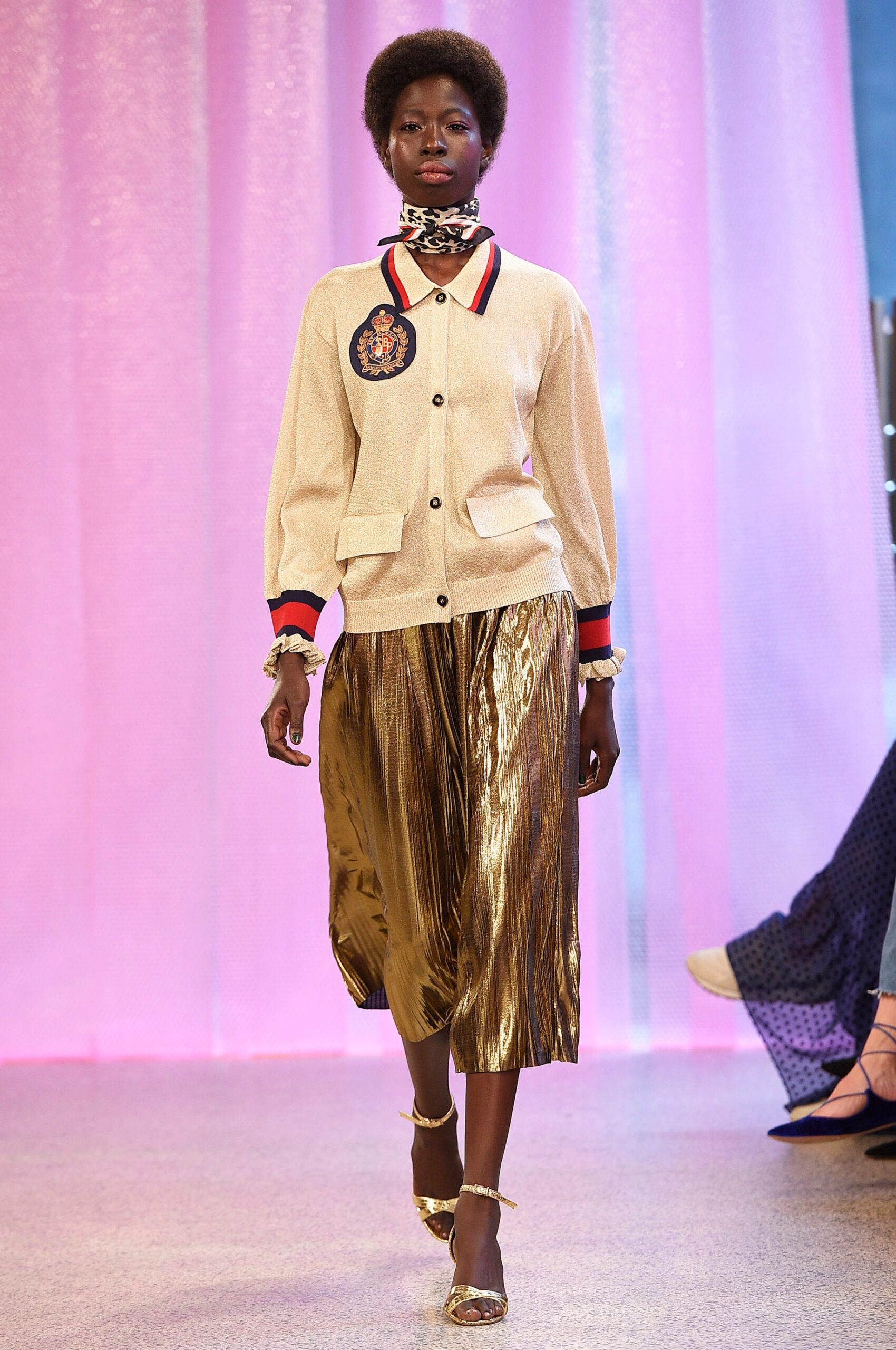 beige fitted jacket with gold pleated skirt