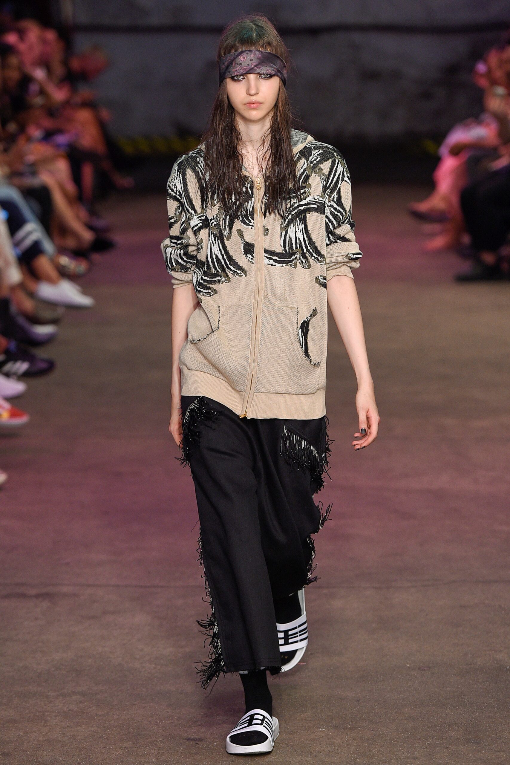 beige hoodie with fringed black pants