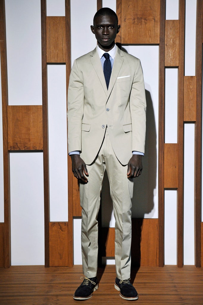 beige tailored suit with blue tie