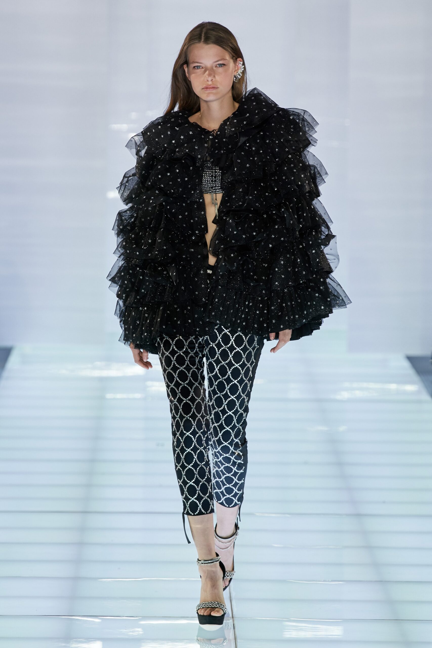 black ruffled top and printed pants