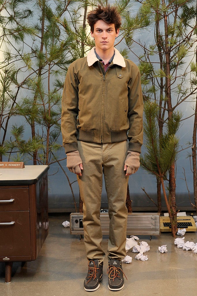 green fitted jacket and beige pants