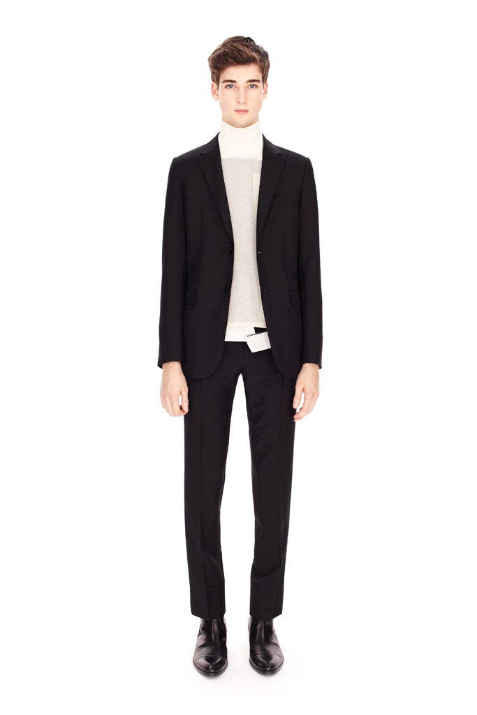 black tailored suit with white turtleneck