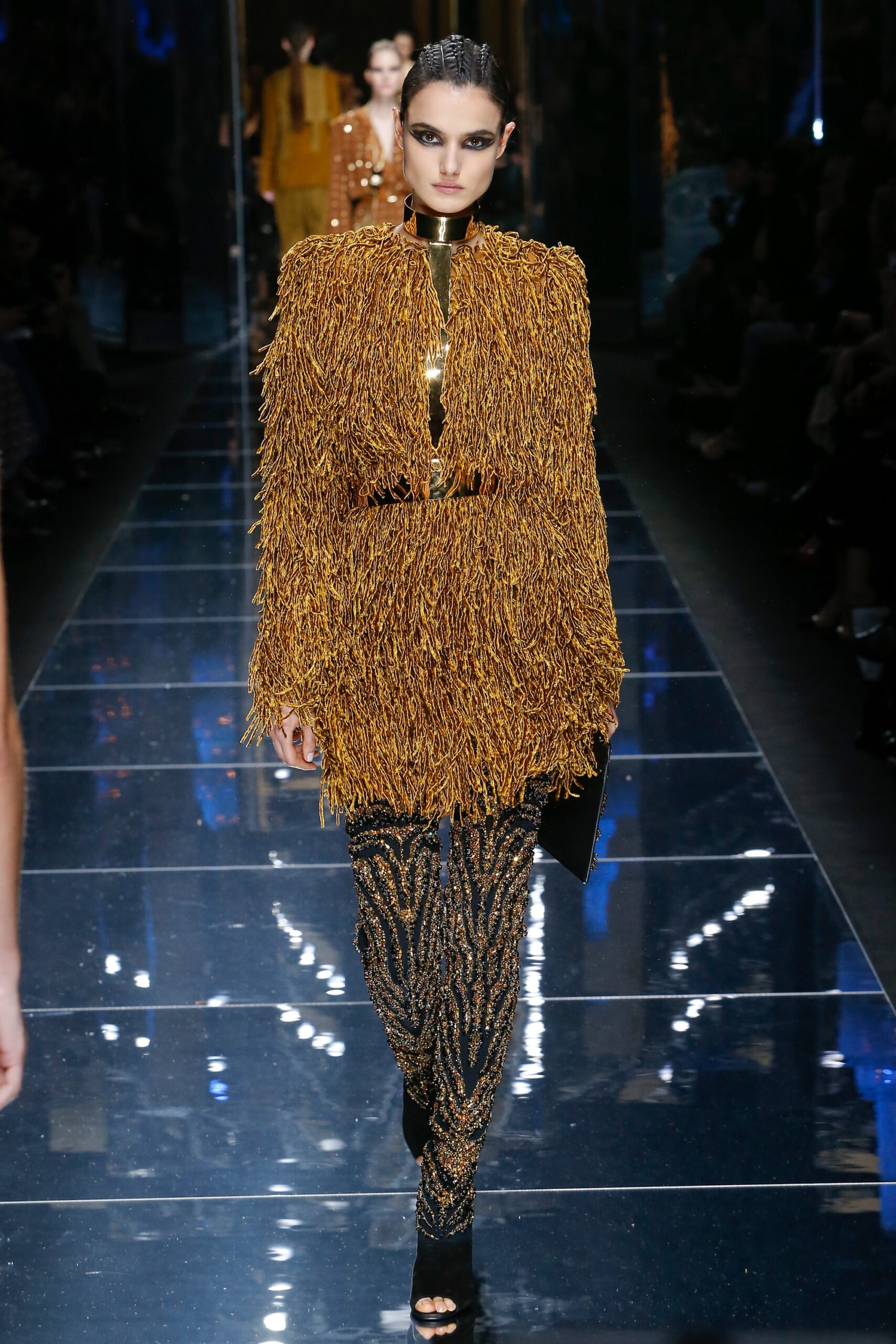 gold fringed top with black pants