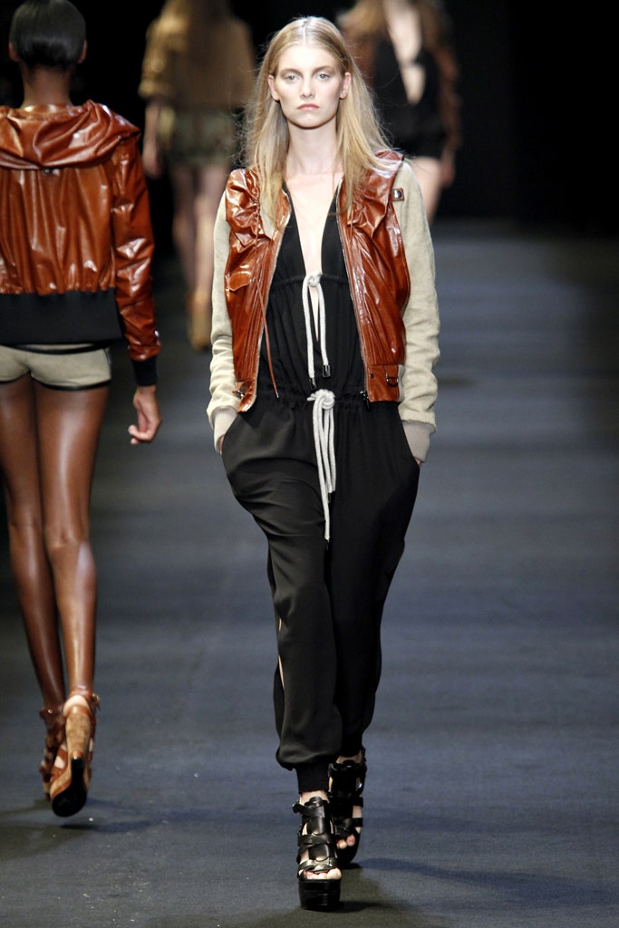 brown leather fitted jacket and black jumpsuit