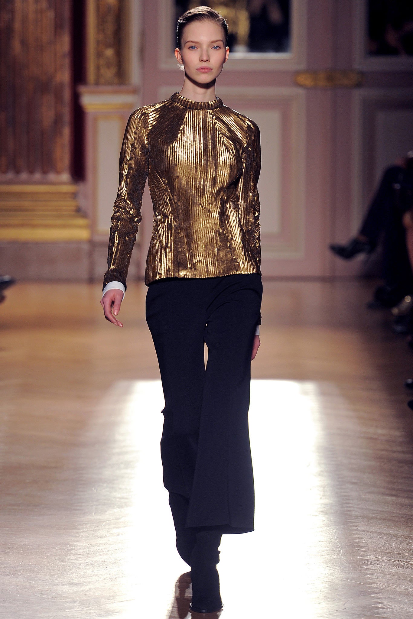 gold fitted top with black tailored pants