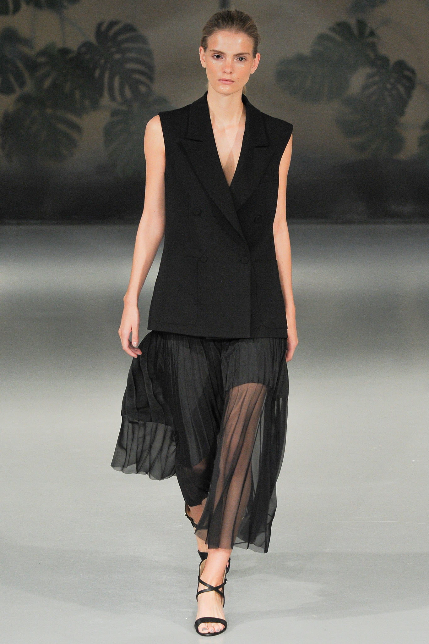 black sleeveless blazer and flowing skirt