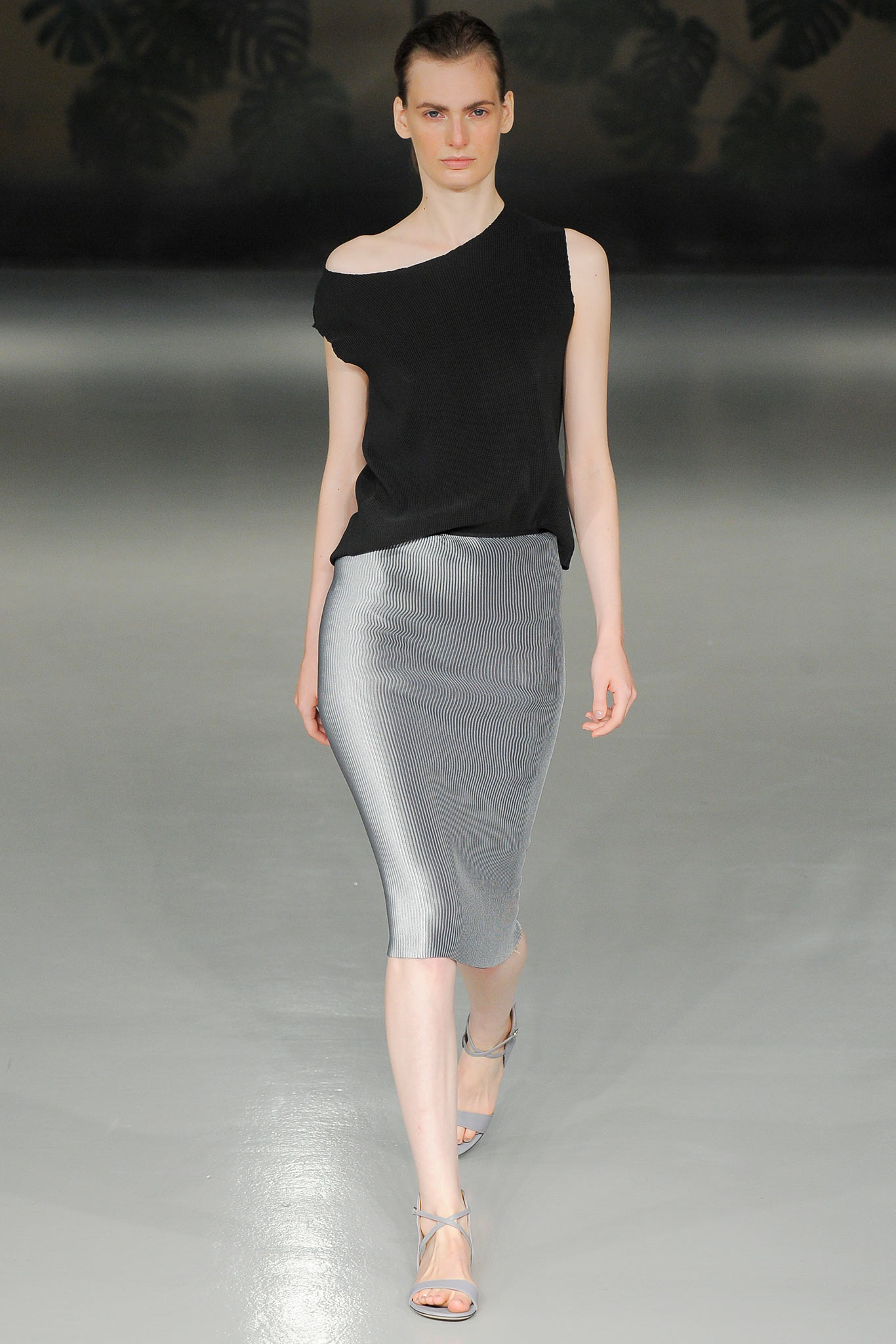 black asymmetric top and silver pencil skirt