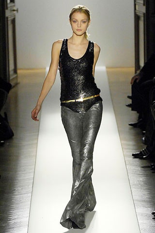 black sequined top and gray flared pants