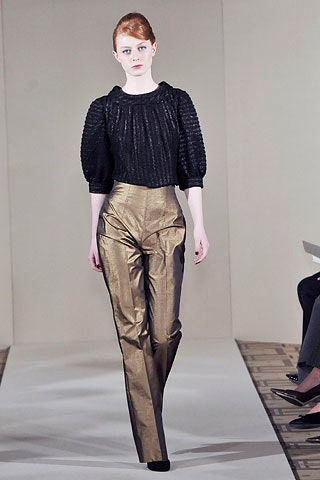black silk fitted top and gold tailored pants