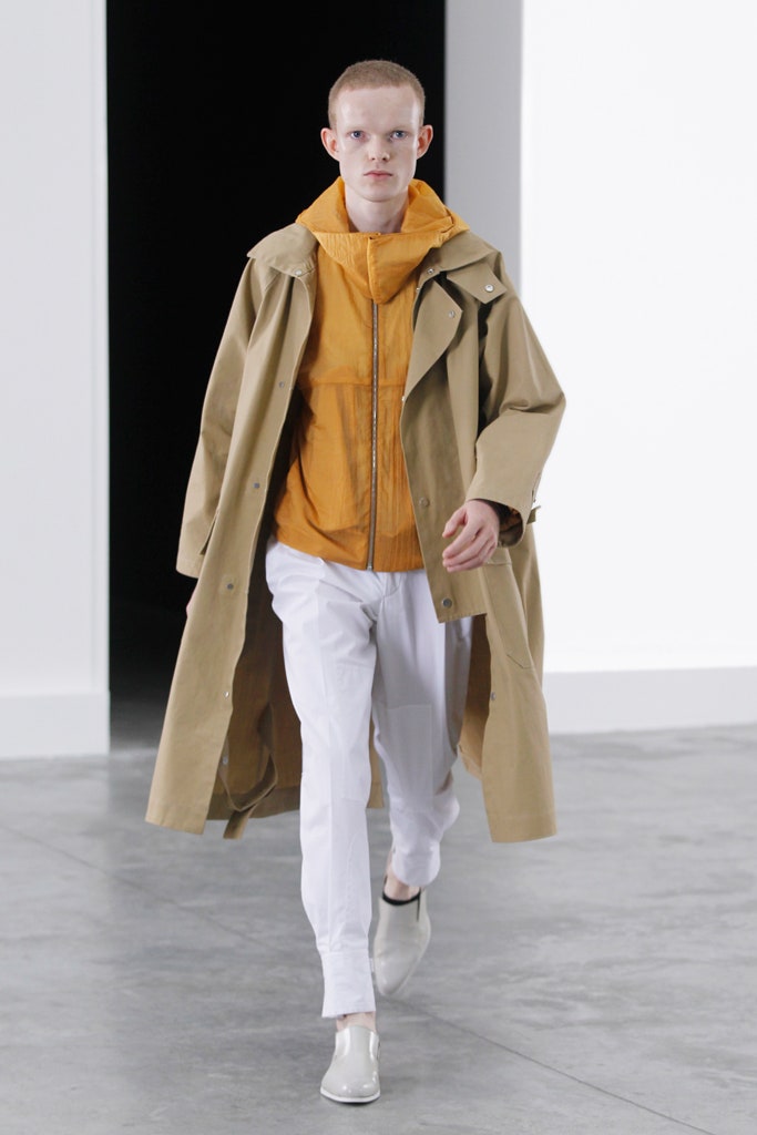 beige coat orange hoodie white pants