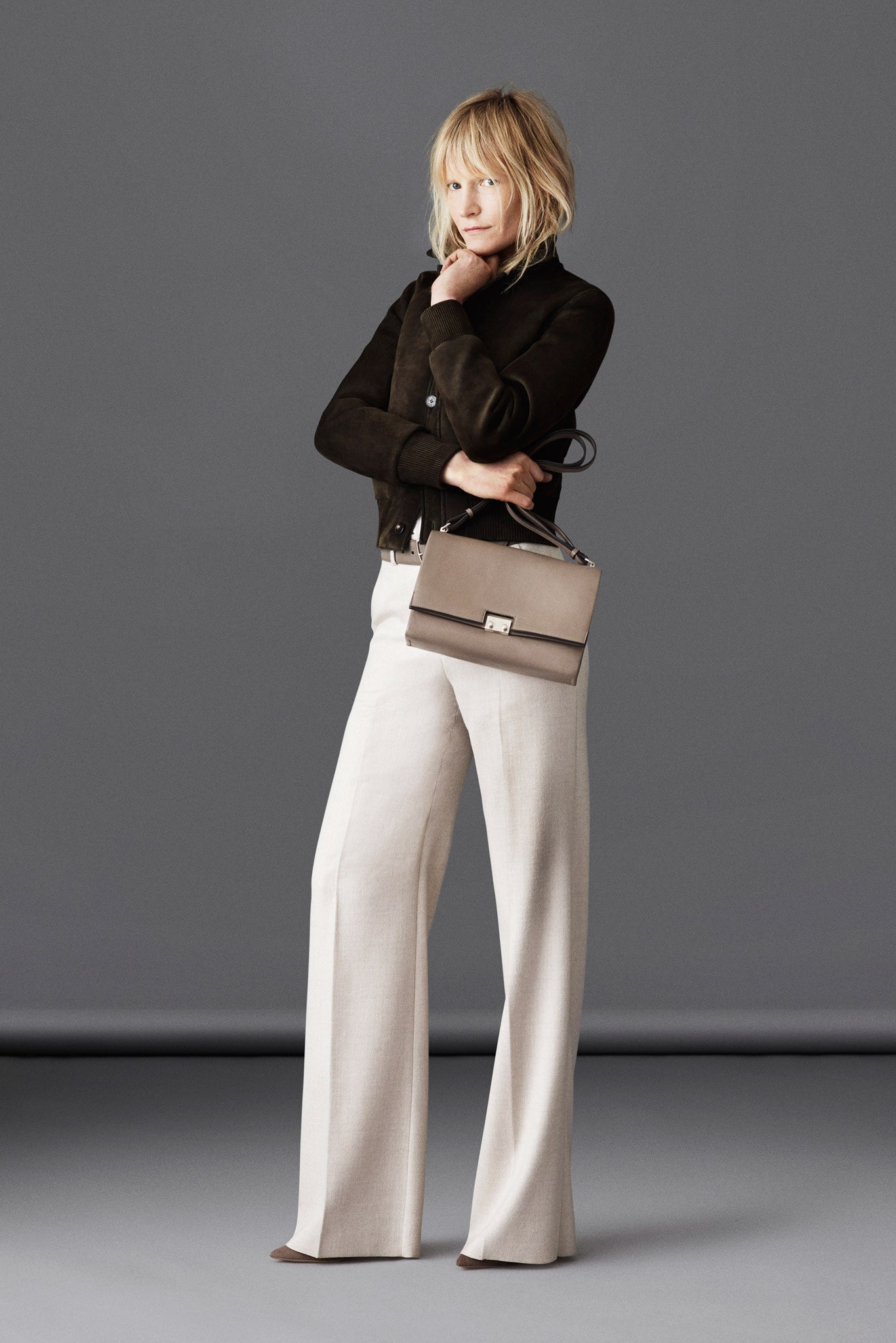 brown suede fitted jacket and beige wide-leg pants