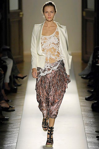 white lace sleeveless top with multi-colored pants