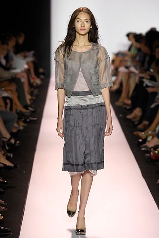 gray sheer top and pleated skirt