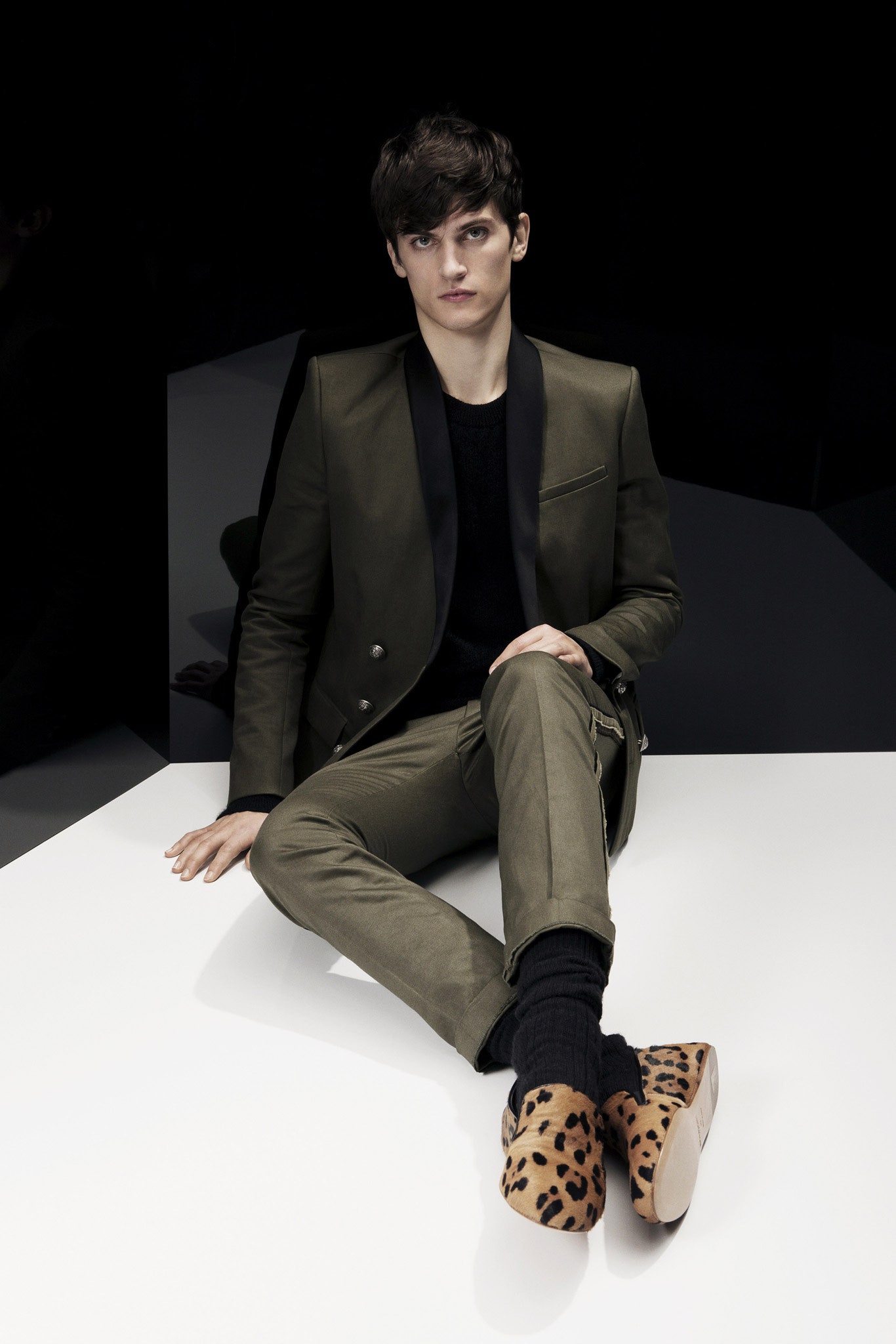 green tailored suit with animal-print shoes