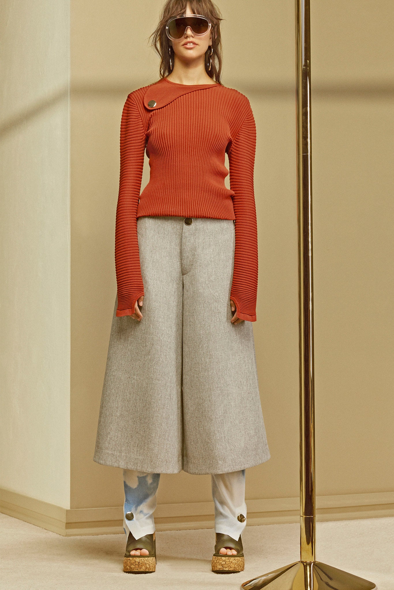 orange fitted top with gray wide-leg pants