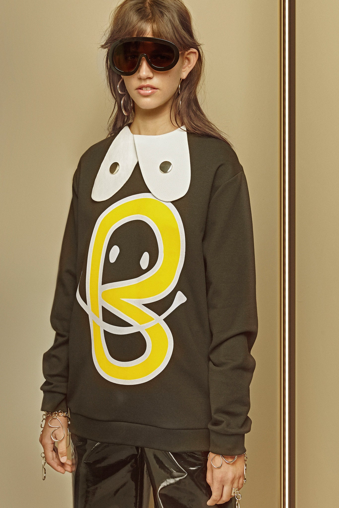 black relaxed sweater with printed design