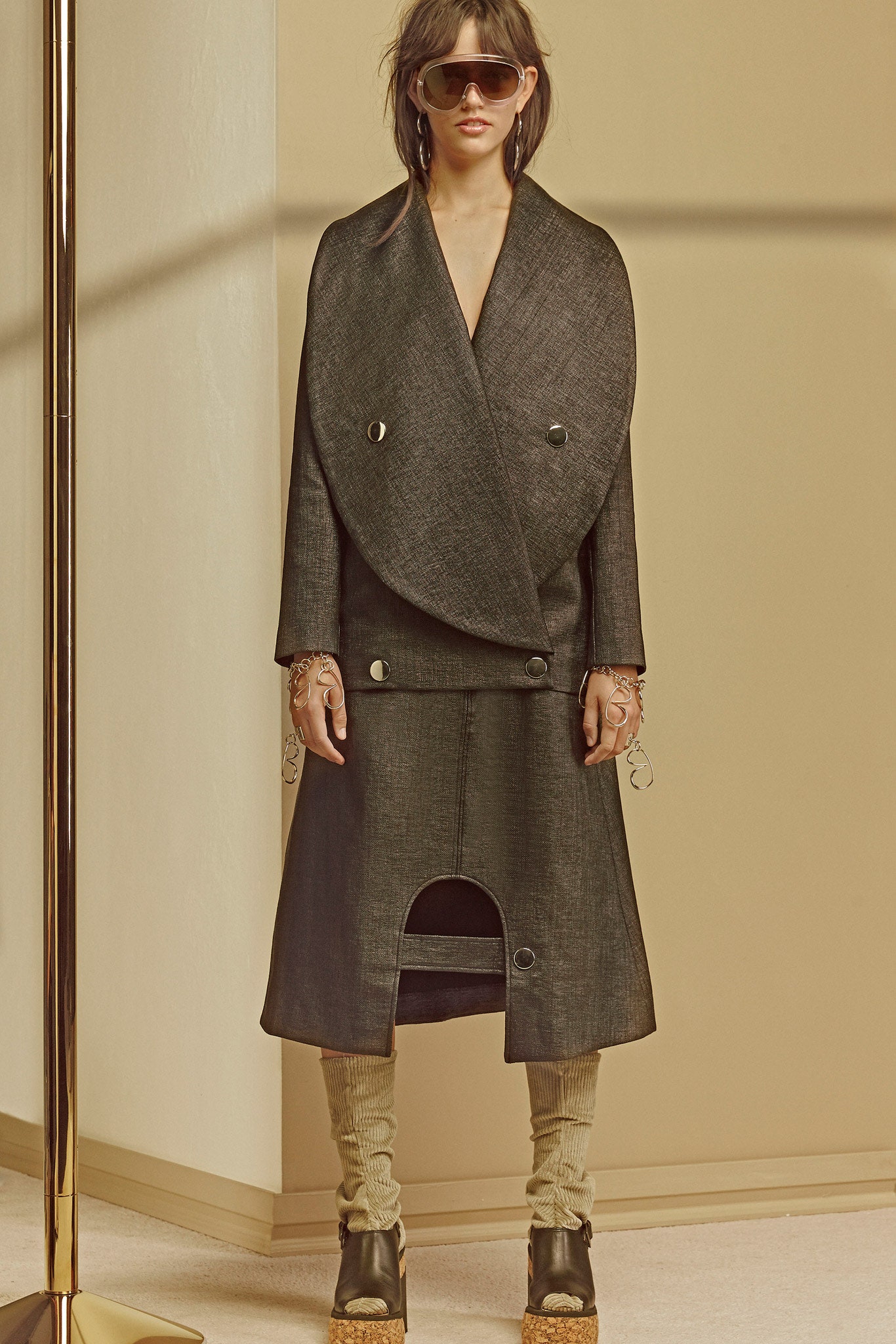 black denim coat with beige pants