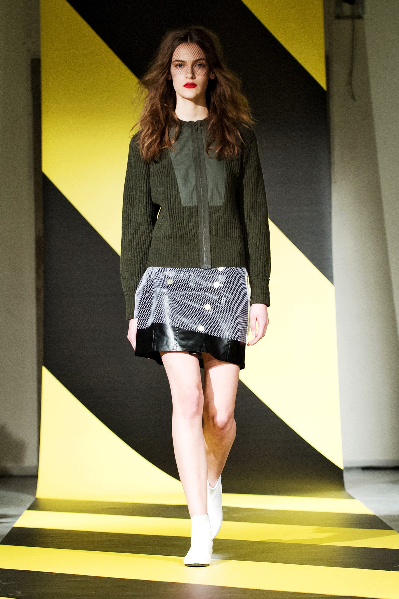 fitted green jacket and black skirt