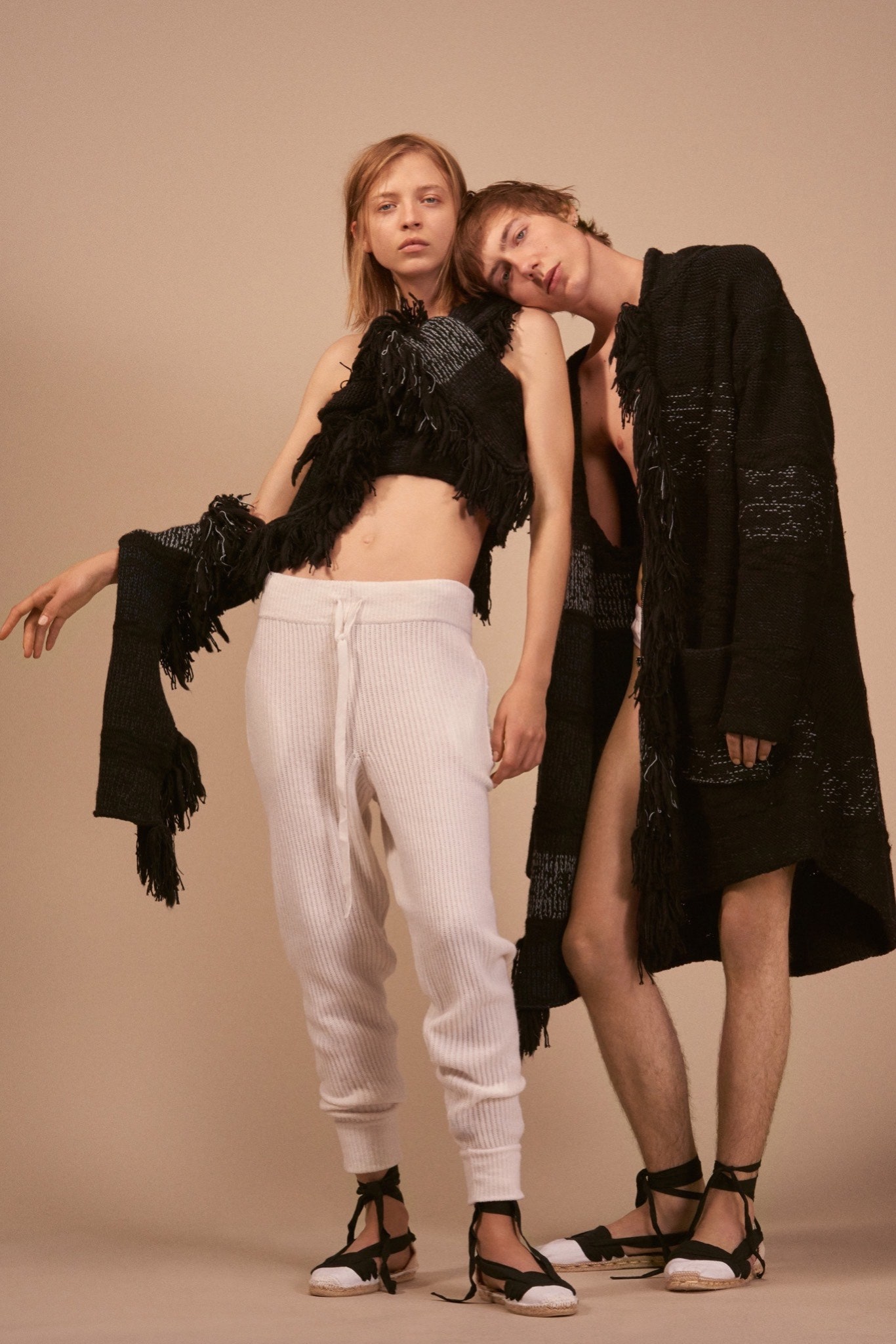 black fringed top with white pants