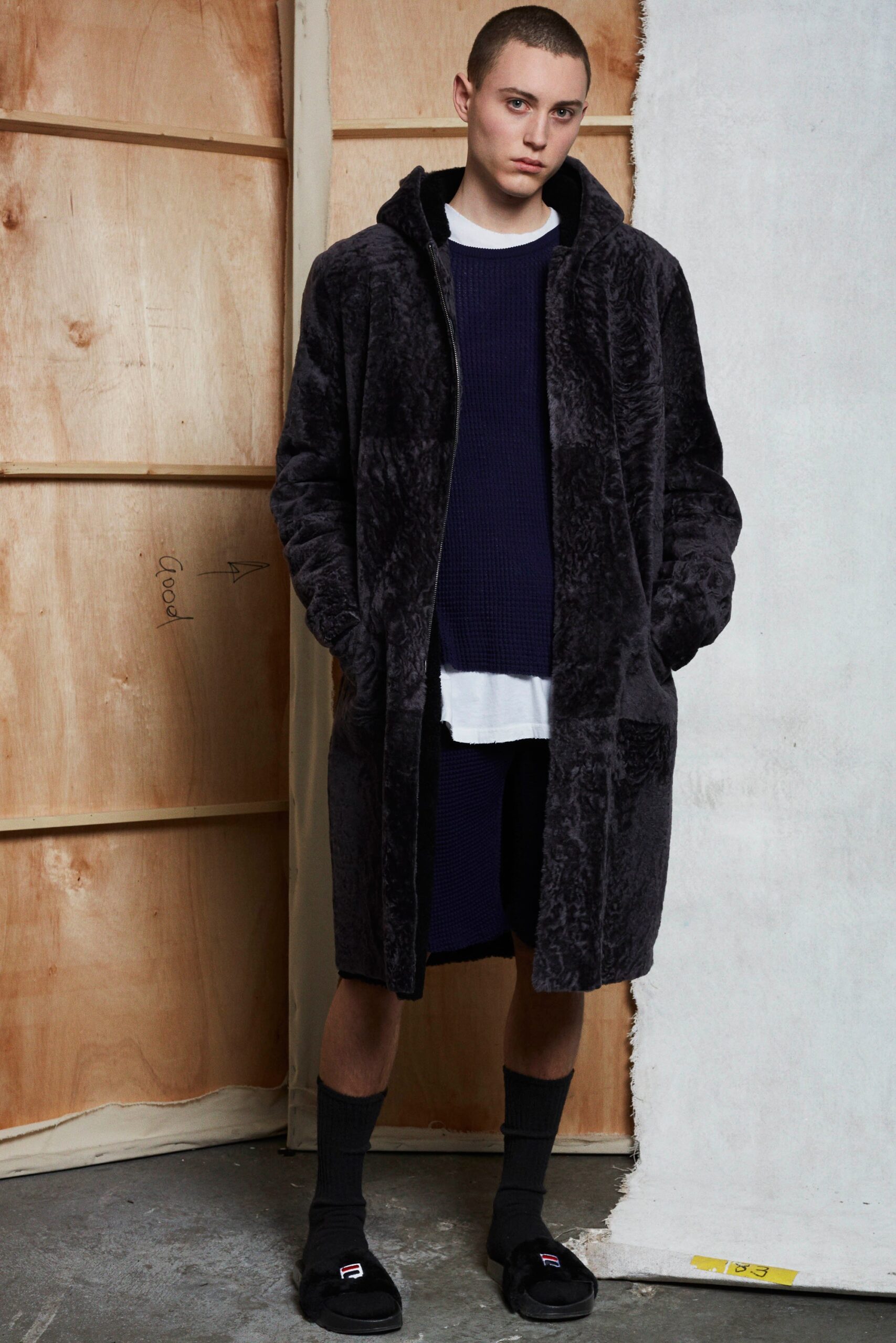 black faux-fur coat with navy dress