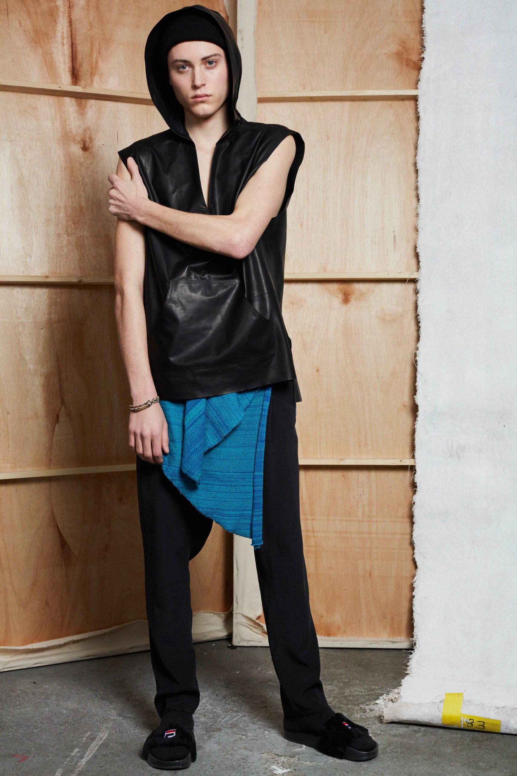 black leather hooded top with relaxed pants
