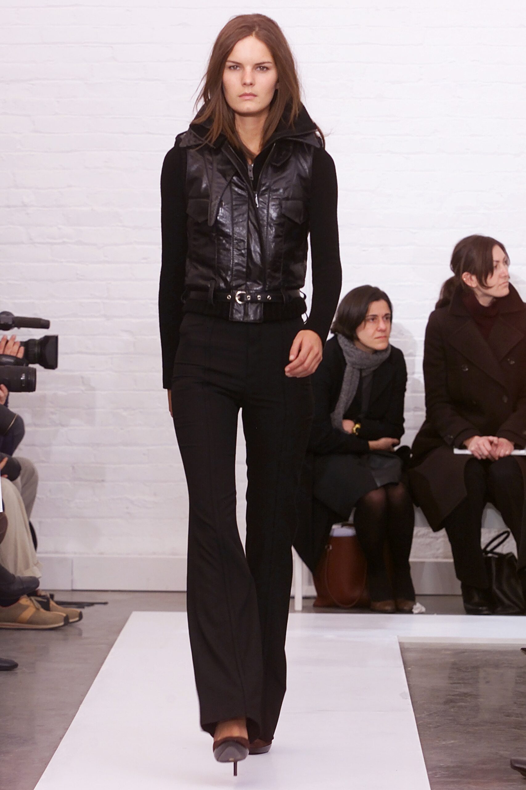 black leather vest and flared pants