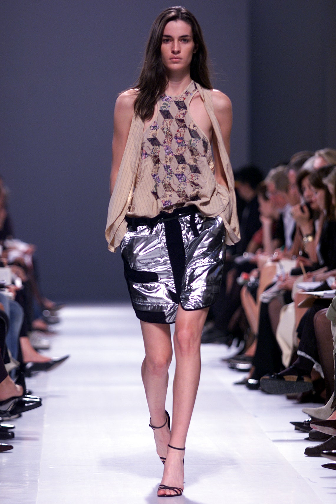 beige embroidered silk top and silver vinyl shorts