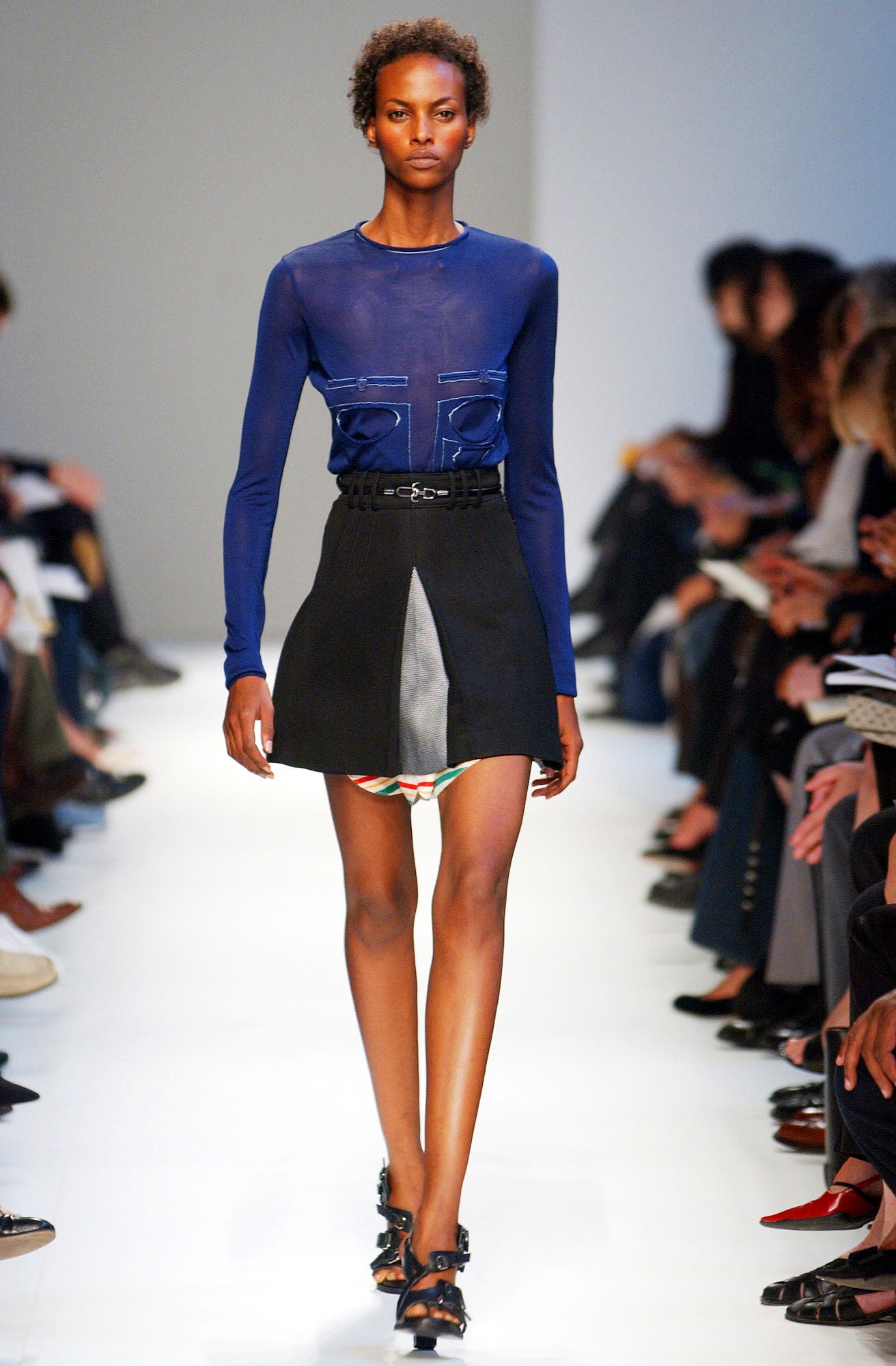 blue fitted silk top and black mini skirt