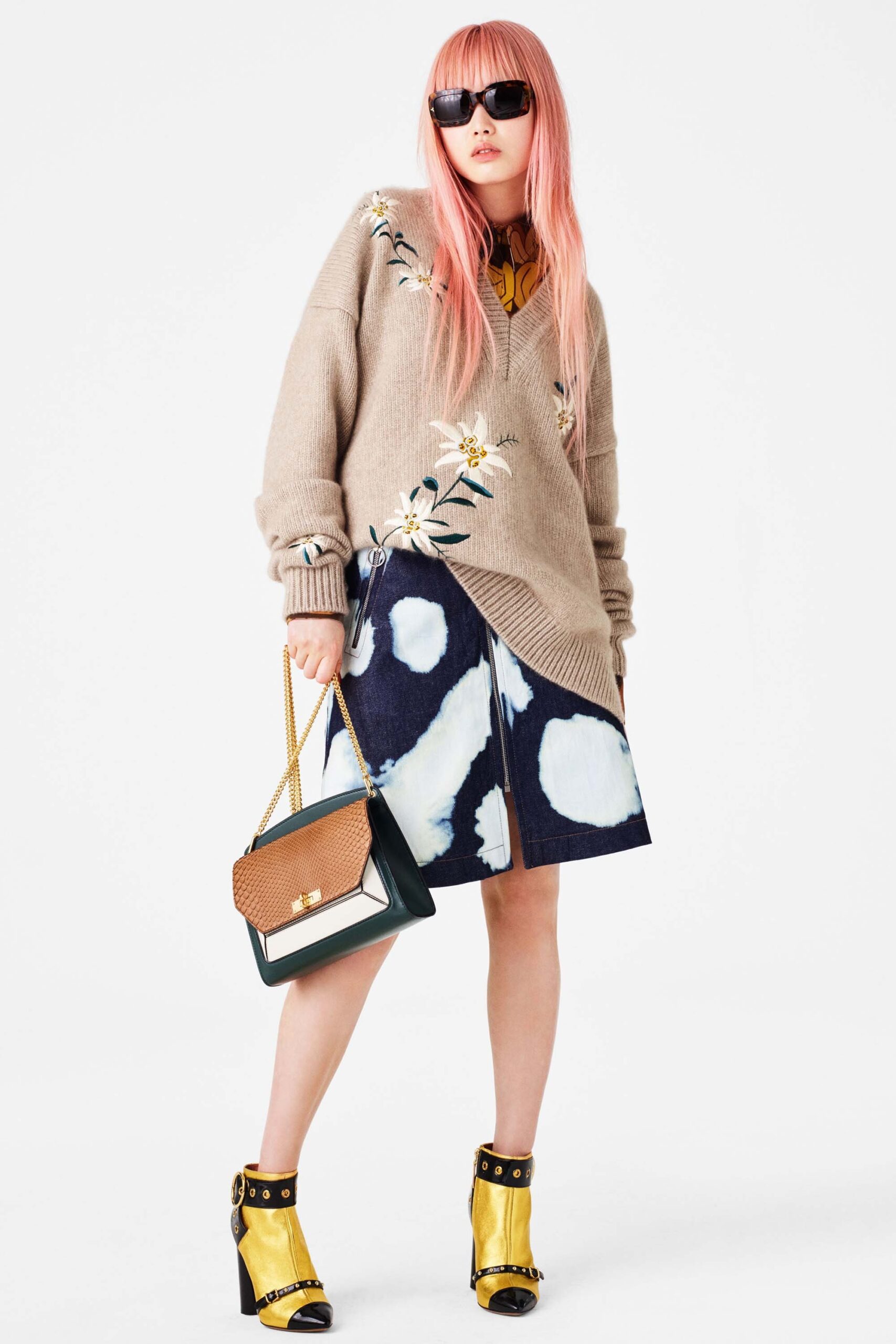 beige embroidered sweater and blue skirt