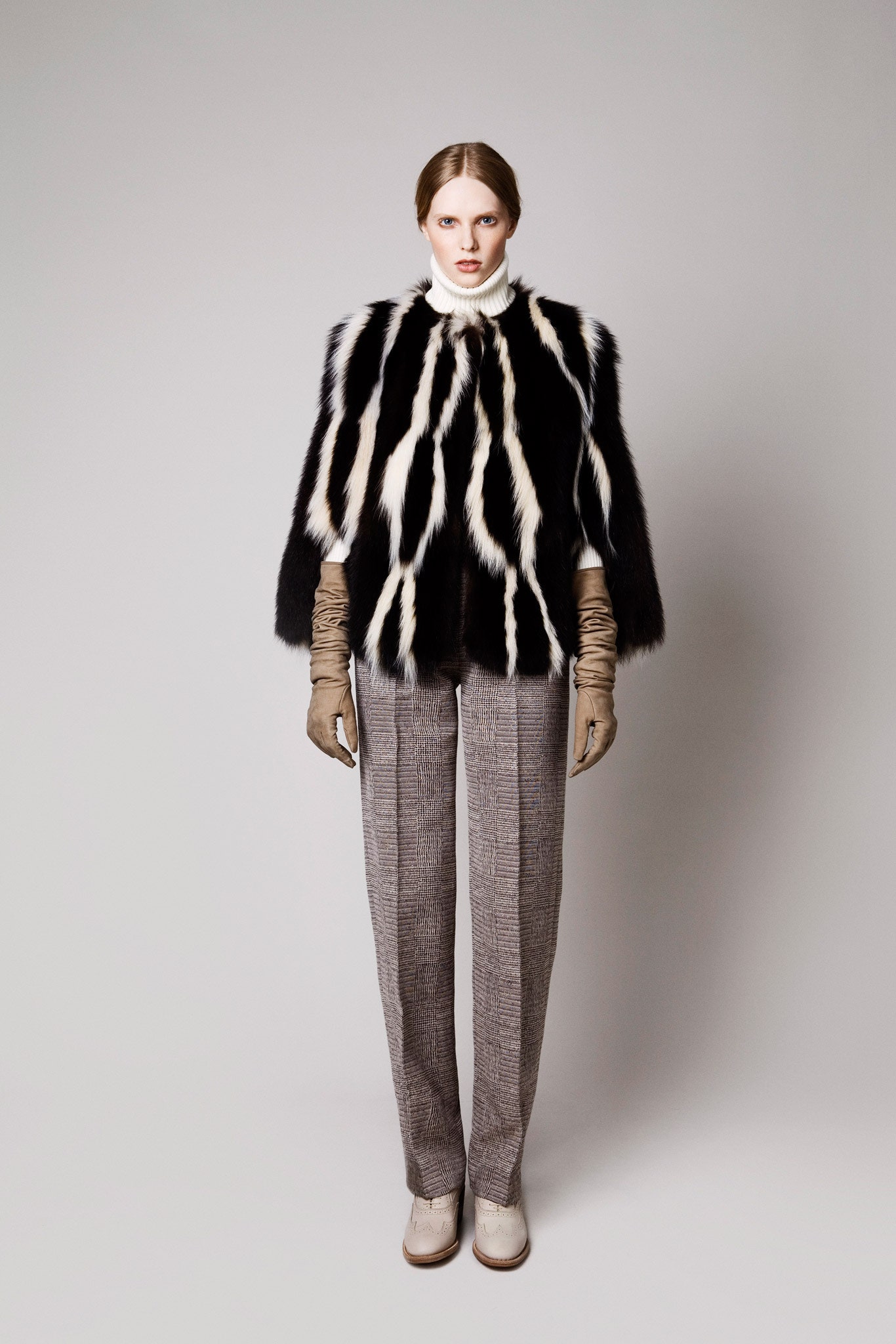 black and white fur cape with tailored pants