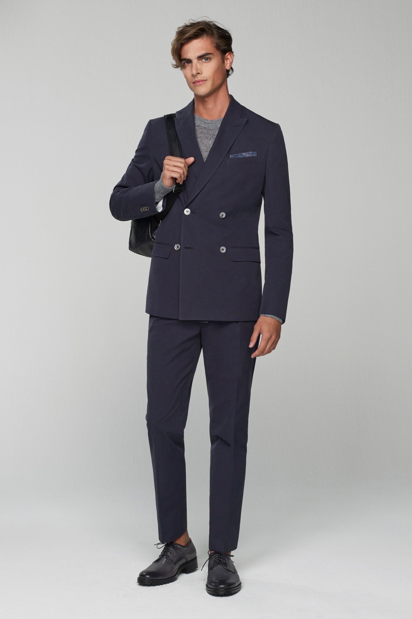 blue tailored suit with gray t-shirt