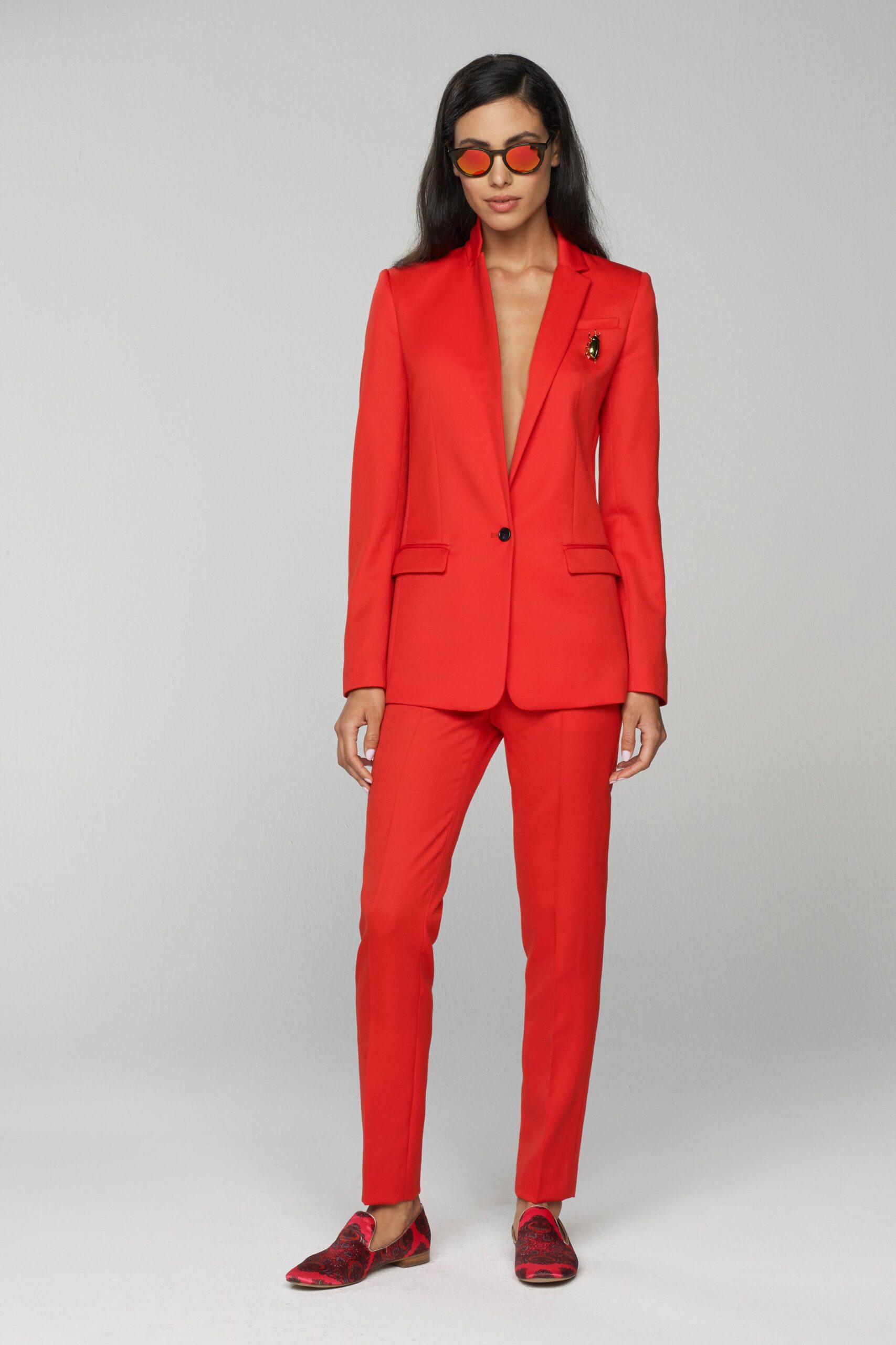 red tailored suit with printed shoes
