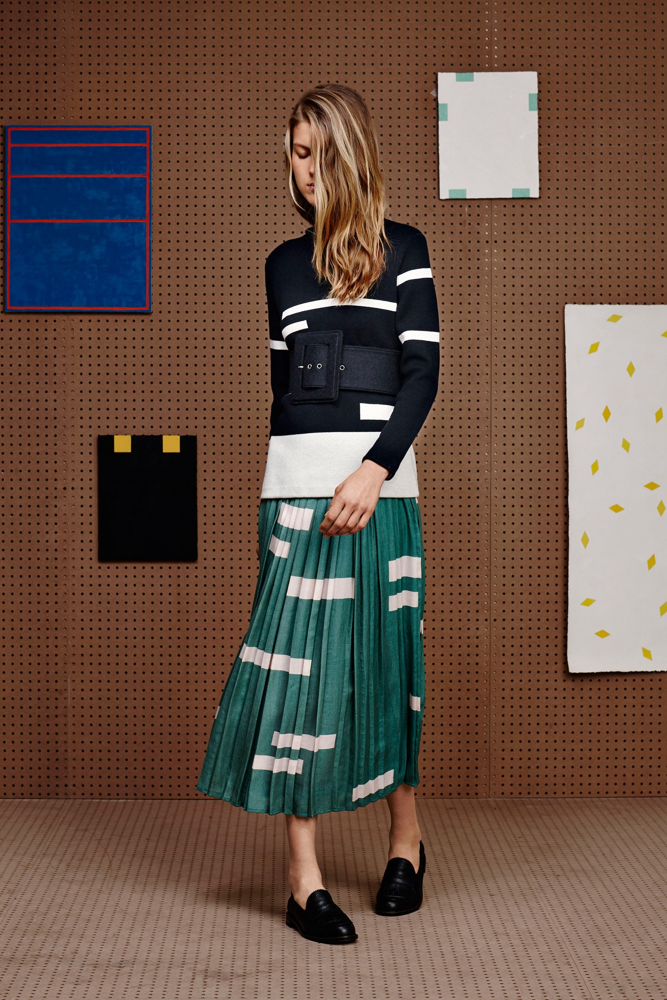 black and white striped top with green pleated skirt