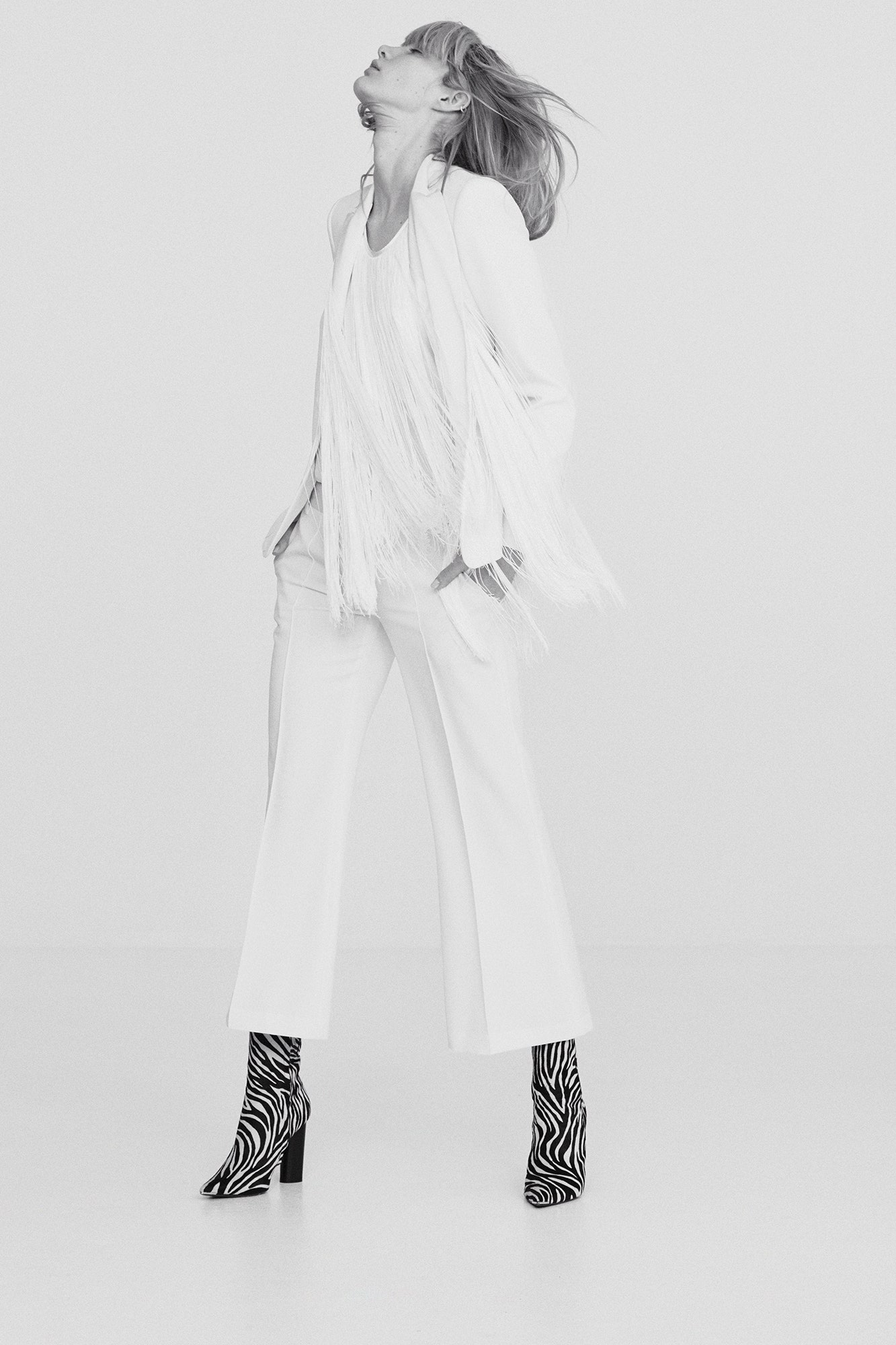 white fringed blazer with flared pants