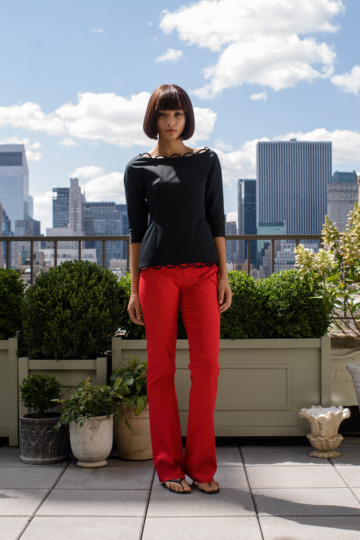 black fitted top with red pants