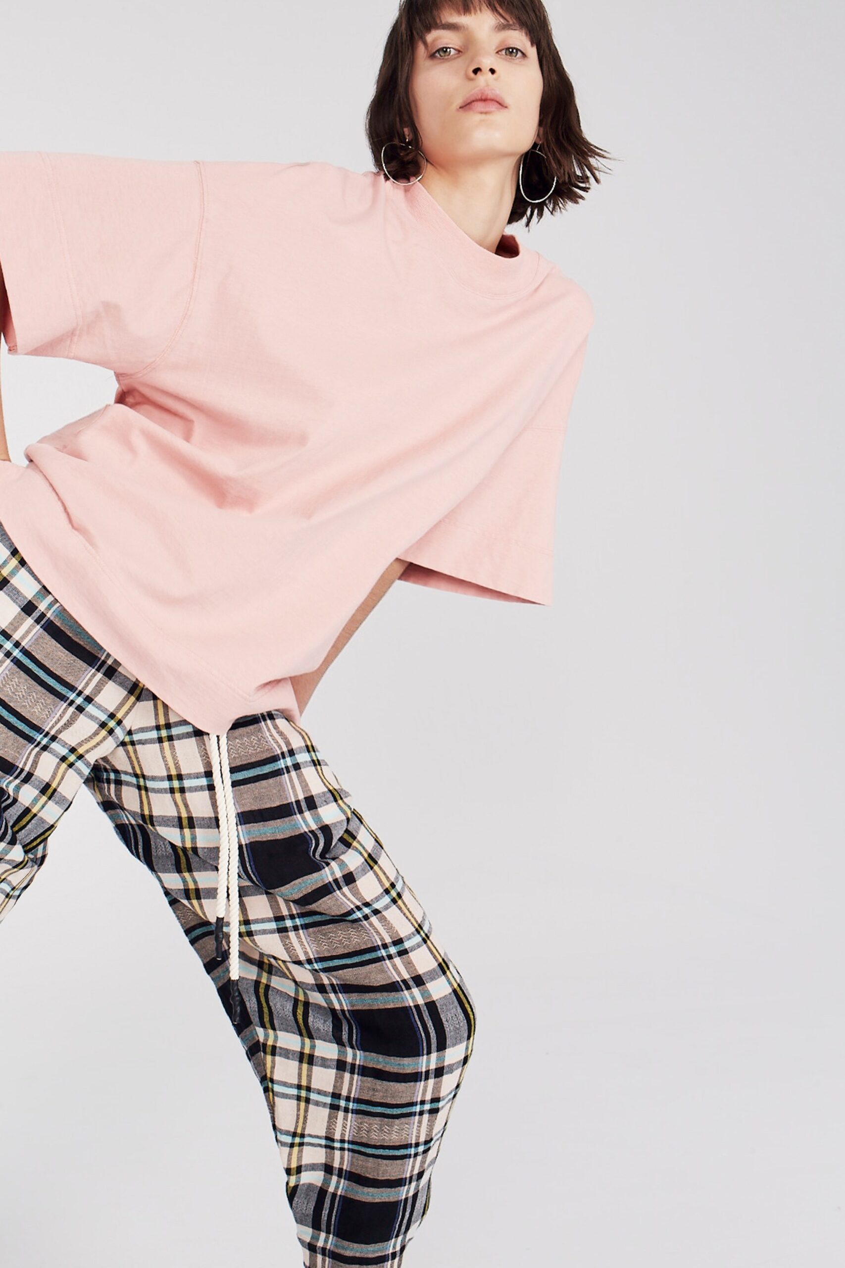 pink oversized t-shirt and checked pants